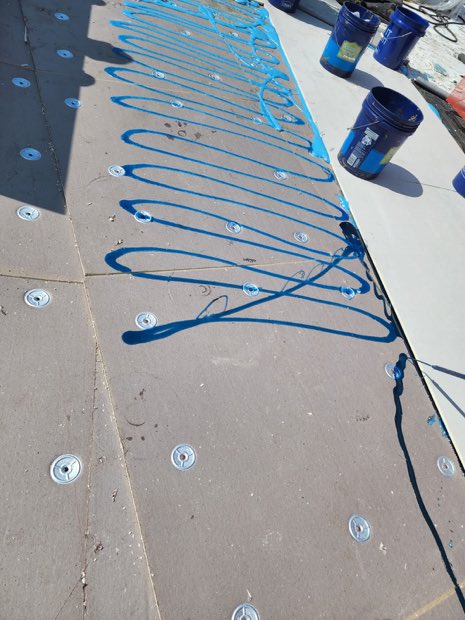 Adhesive applied in ribbons across the substrate, ready for the next board.