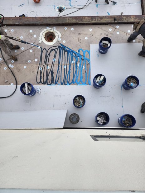 Fastener and plate pattern across insulation board before the membrane is welded.