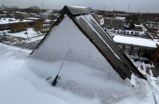 Snow load across a mansard section and the flat roof beyond.