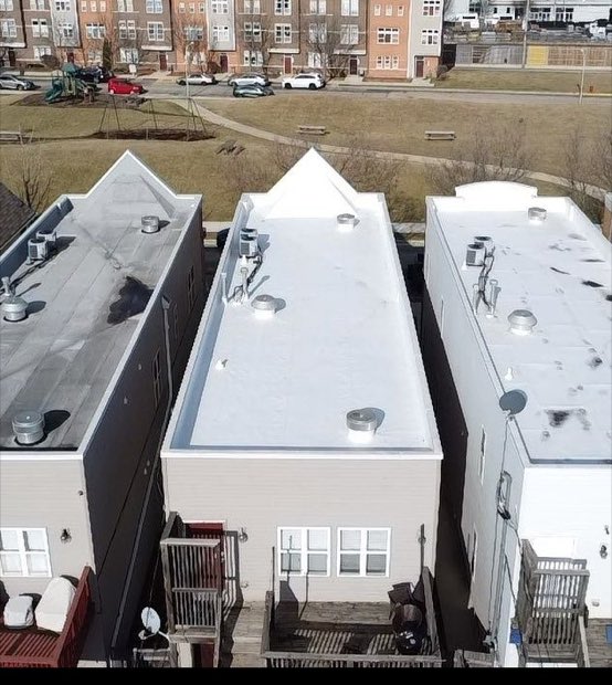 Completed white roofs stepping across adjoining building sections.