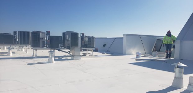 Rooftop mechanical units set across a completed white roof.