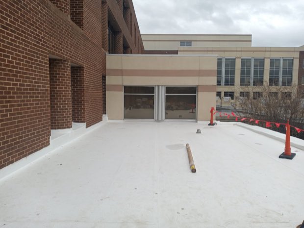 Masonry and precast wall meeting a completed roof deck.