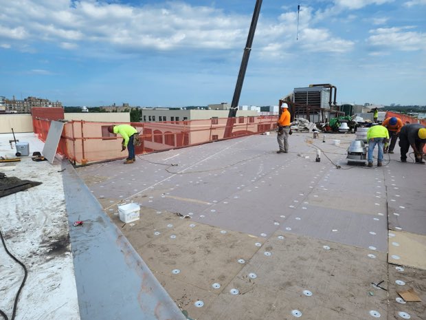 Crane lifting material to a roof during production.