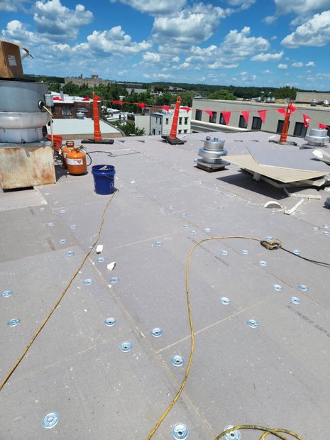 Buckets and boards staged across a roof in production.