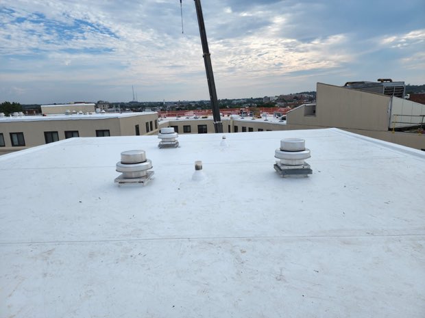 Vents and chimney penetrations on a finished roof.