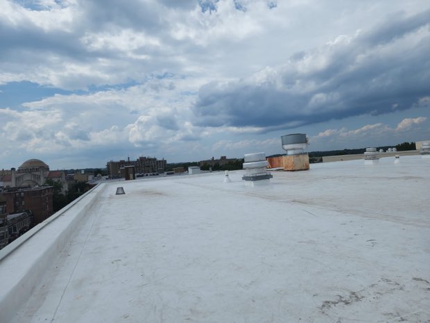 Wide completed roof field on an overcast day.