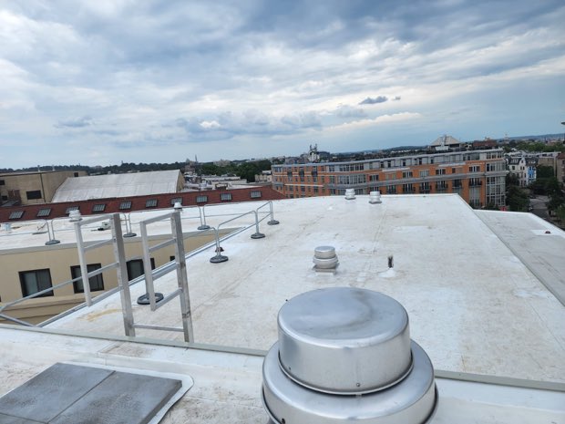 Guard rails and mechanical equipment on a finished roof.
