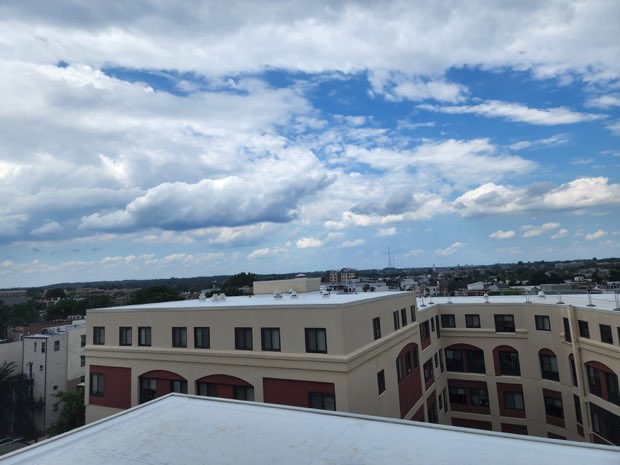 Completed white roof against a rendered facade.
