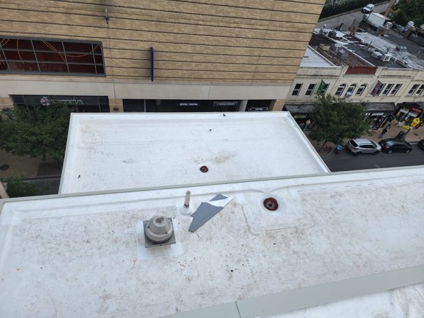 Roof edge and coping above a commercial street.
