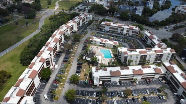 Multi-building property with completed reflective roofing throughout.