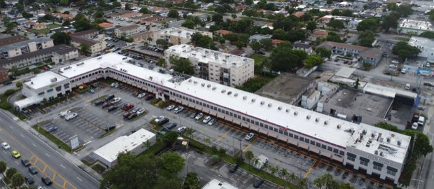 Extended commercial building from above, completed roof the full length.