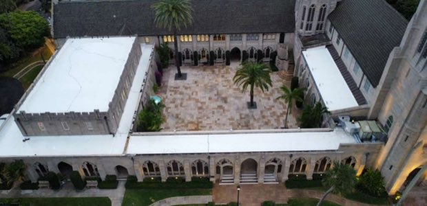 Courtyard property with arcaded elevations and completed roofs on every wing.